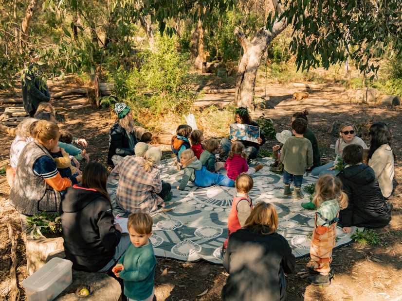 Children and their parents / carers listening to a story at the Y's Bush Playgroup